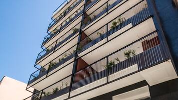A multi-story building with balconies, large windows, and a sign that reads "MAPPART RESIDENCY".