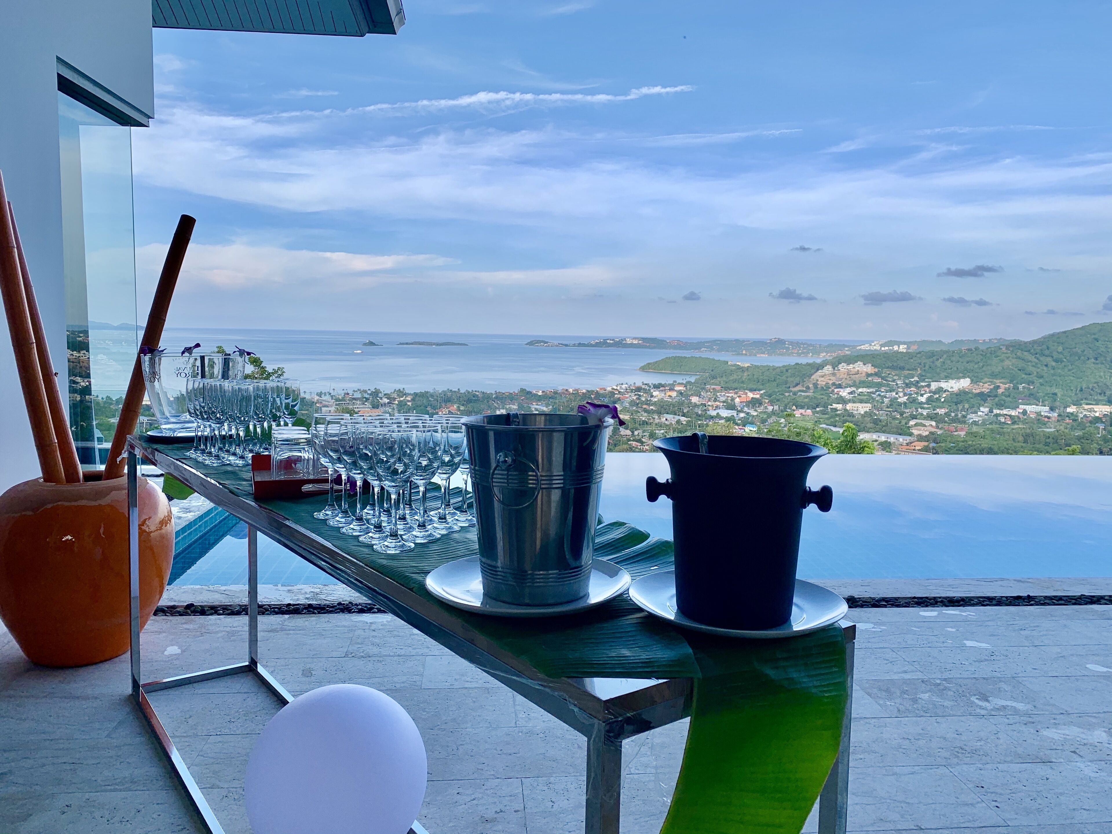 A table with a view of the sea and a cityscape.