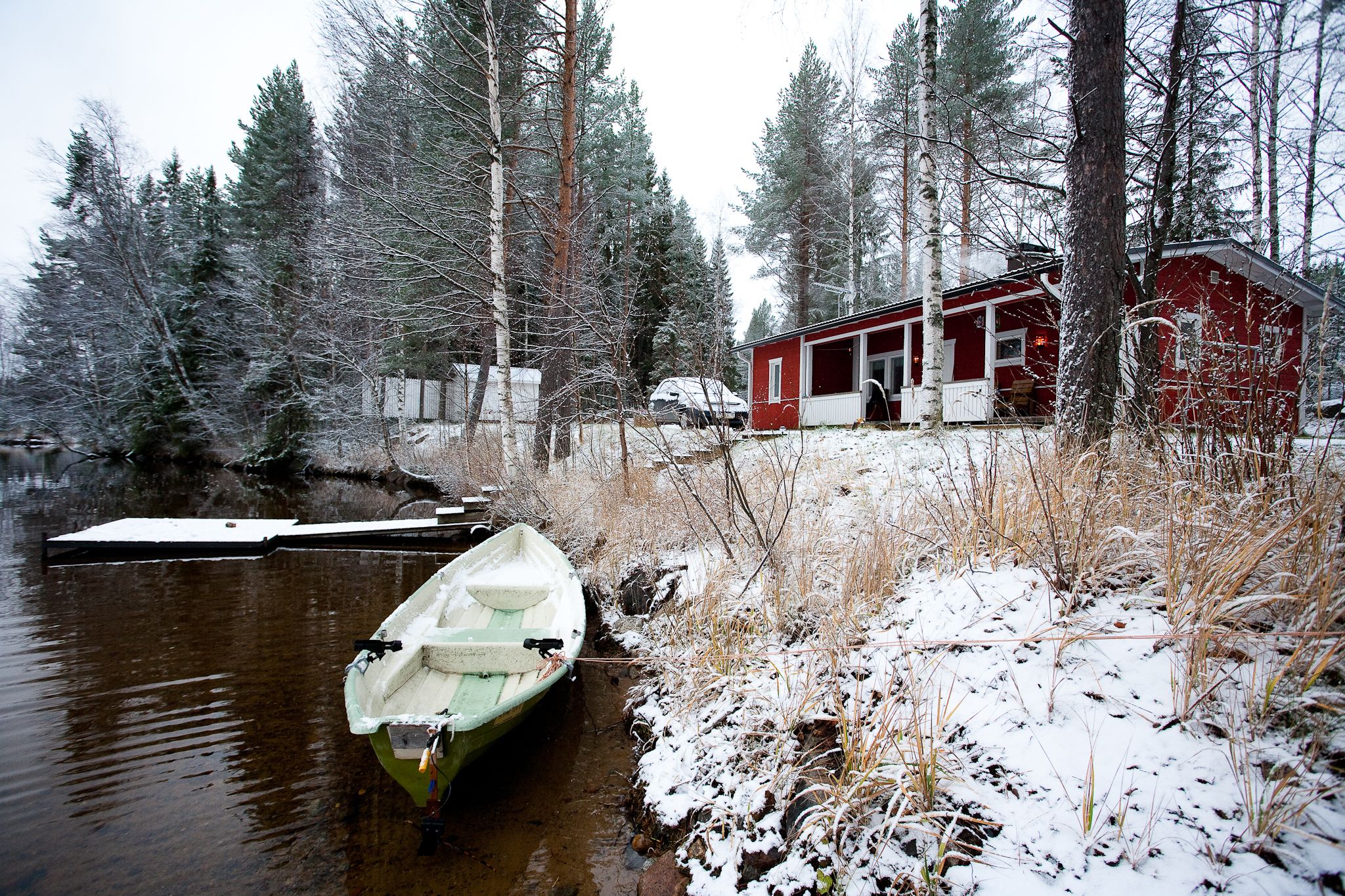 A cabin with a dock and a boat.