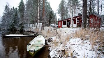 A cabin with a dock and a boat.