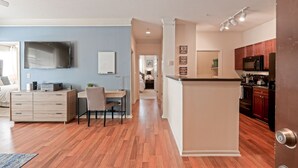A modern apartment with a kitchen, dining area, and a living room.