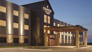 A modern building with a sign reading "Country Inn & Suites by Radisson." - Country Inn & Suites by Radisson Lawrence (Lawrence)