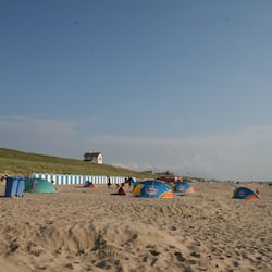 On the beach, white sand, sun-loungers, beach umbrellas