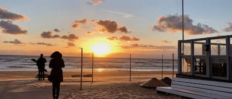 On the beach, white sand, sun loungers, beach umbrellas