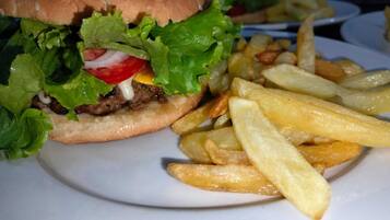 A plate with a hamburger and French fries.