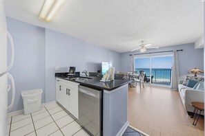 Exclusive Condo, 1 Bedroom, Balcony, Beach View | Private kitchen | Fridge, microwave, oven, stovetop - Tradewinds Condos by Hosteeva (Orange Beach)