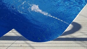 A swimming pool with clear blue water, surrounded by a white fence and a concrete deck. - Punta Umbria, Huelva Andalucia Costa de la Luz 2 bedrooms swimming pool  (Punta Umbría)