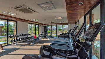 A modern gym with treadmills, dumbbells, and exercise equipment.