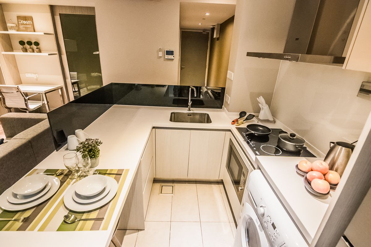 A modern kitchen with a central island, a sink, and a stove.
