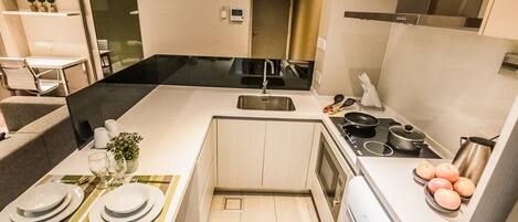 A modern kitchen with a central island, a sink, and a stove.