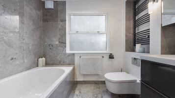 Combined shower/bathtub, hair dryer, towels, soap