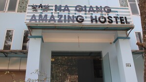The exterior of Ha Giang Amazing Hostel with a prominent sign above the entrance. - Ha Giang Amazing Hostel (Ha Giang 2)