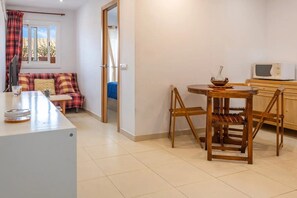 Cozy living space with a kitchenette, dining area, and sofa.