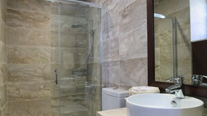 A modern bathroom with a glass-enclosed shower, a white toilet, and a large sink with a mirror above. - Kalopanayiotis Cottage  In The Centre (Nicosia)