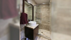 A modern bathroom with a glass shower enclosure, a marble countertop, and a large mirror. - Kalopanayiotis Cottage  In The Centre (Nicosia)