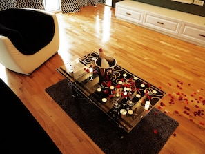 Relax in a clean and contemporary living space with a sofa, coffee table, and cabinet.