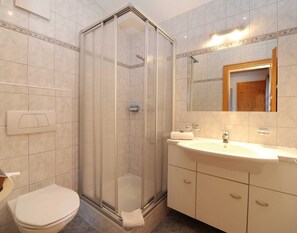 Shower, hair dryer, towels, toilet paper