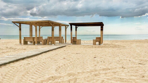 A beach with wooden structures and benches, a wooden walkway, and the ocean in the background. - 2 bedroom stunning home in La Faute sur Mer (La Faute sur Mer)