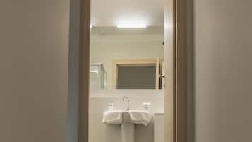 A staircase leading to a bathroom with two white towels hanging on a rack.