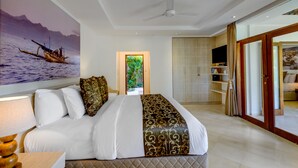 A hotel room with a bed, a painting of a boat on water, a ceiling fan, and a sliding door leading to a balcony. - Villa Vitari (Seminyak)