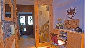 A wooden interior with a desk, chair, and a decorative wall piece.