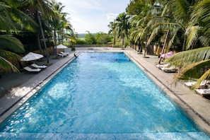 Outdoor pool, open 6 AM to 9:00 PM, pool umbrellas, pool loungers