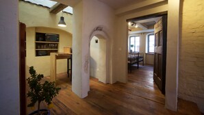 Una cocina amplia con piso de madera, un microondas integrado y una pequeña mesa de comedor.