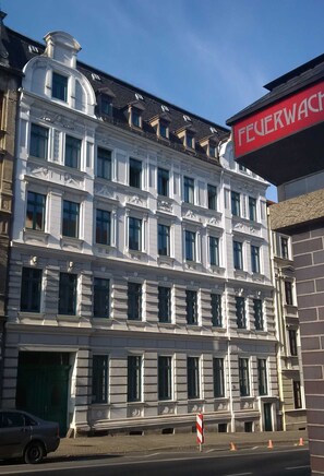 A multi-story building with a prominent red sign reading "FEUERWACHT".
