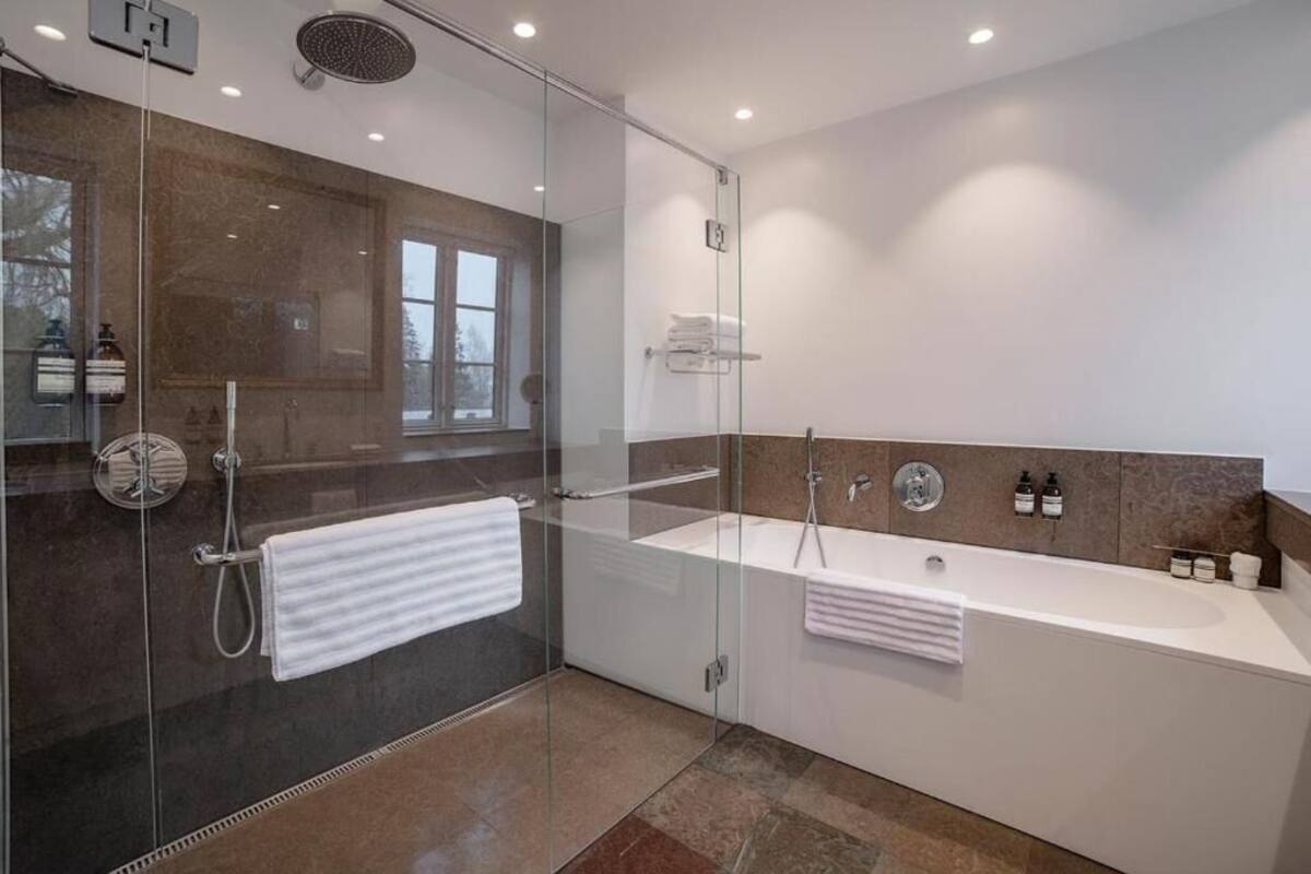 large estate room with bathtub | bathroom | free toiletries, hair dryer, slippers, heated floors