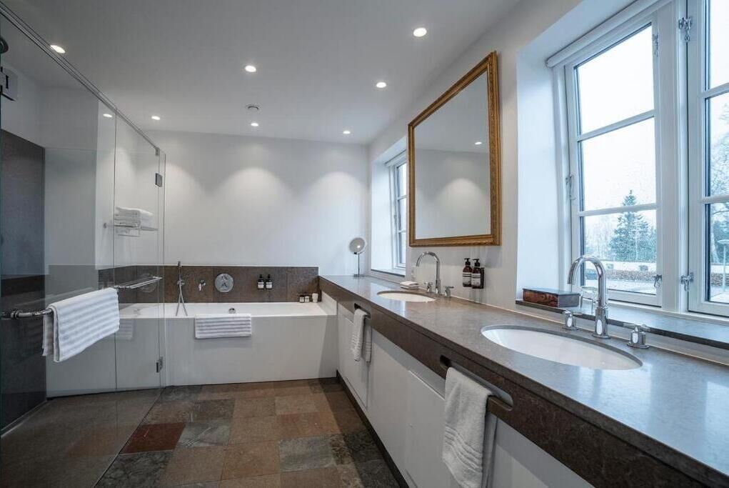 large estate room with bathtub | bathroom | free toiletries, hair dryer, slippers, heated floors