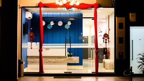 A hotel entrance with a blue wall, red curtains, and a chandelier. - Jenjarom Boutique Hotel (Jenjarom)