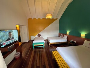 Cozy retreat with a large bed, a smaller bed, and a comfortable bench, perfect for relaxing.