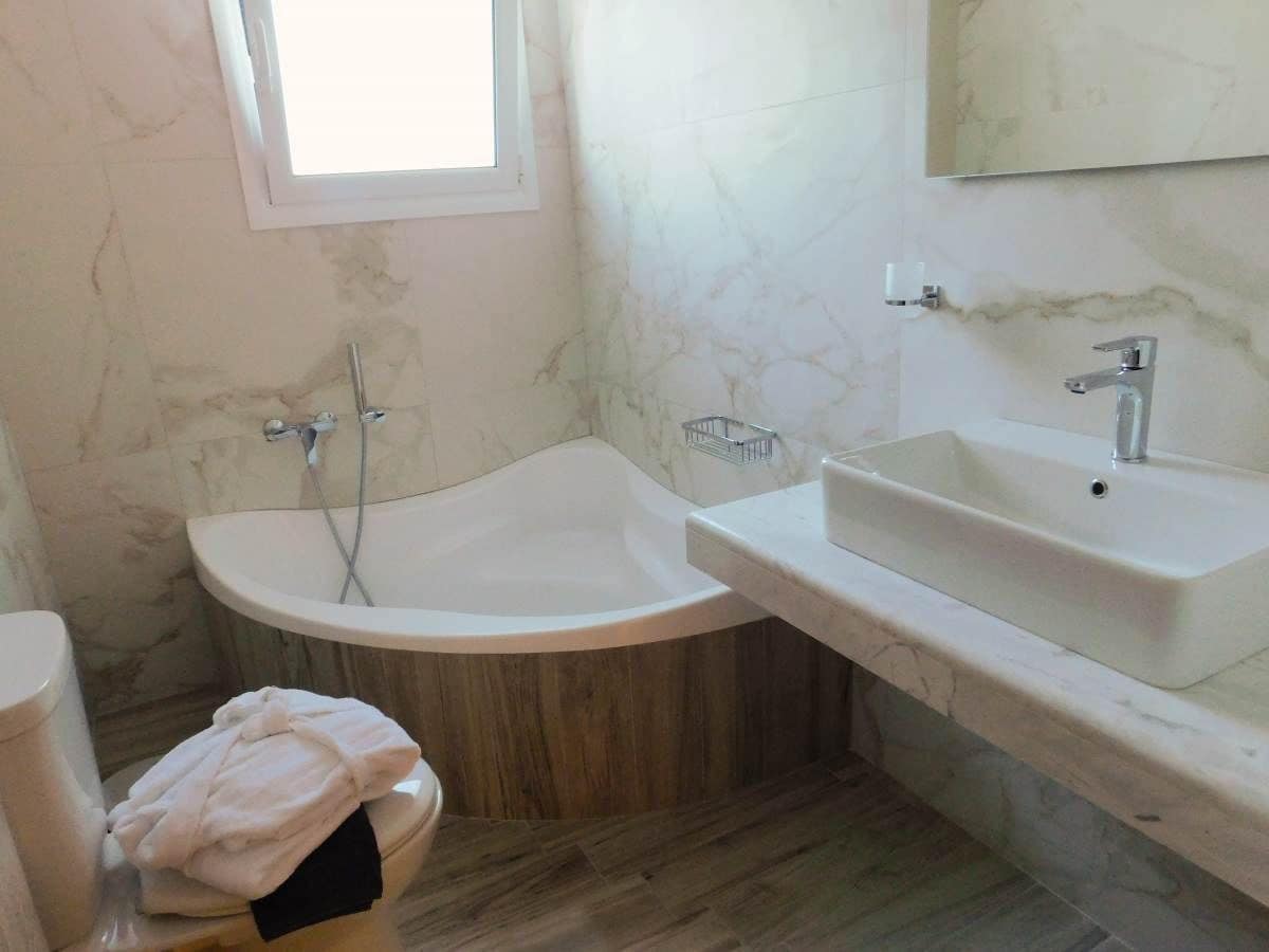 A bathroom with a freestanding bathtub, a sink, and a toilet.