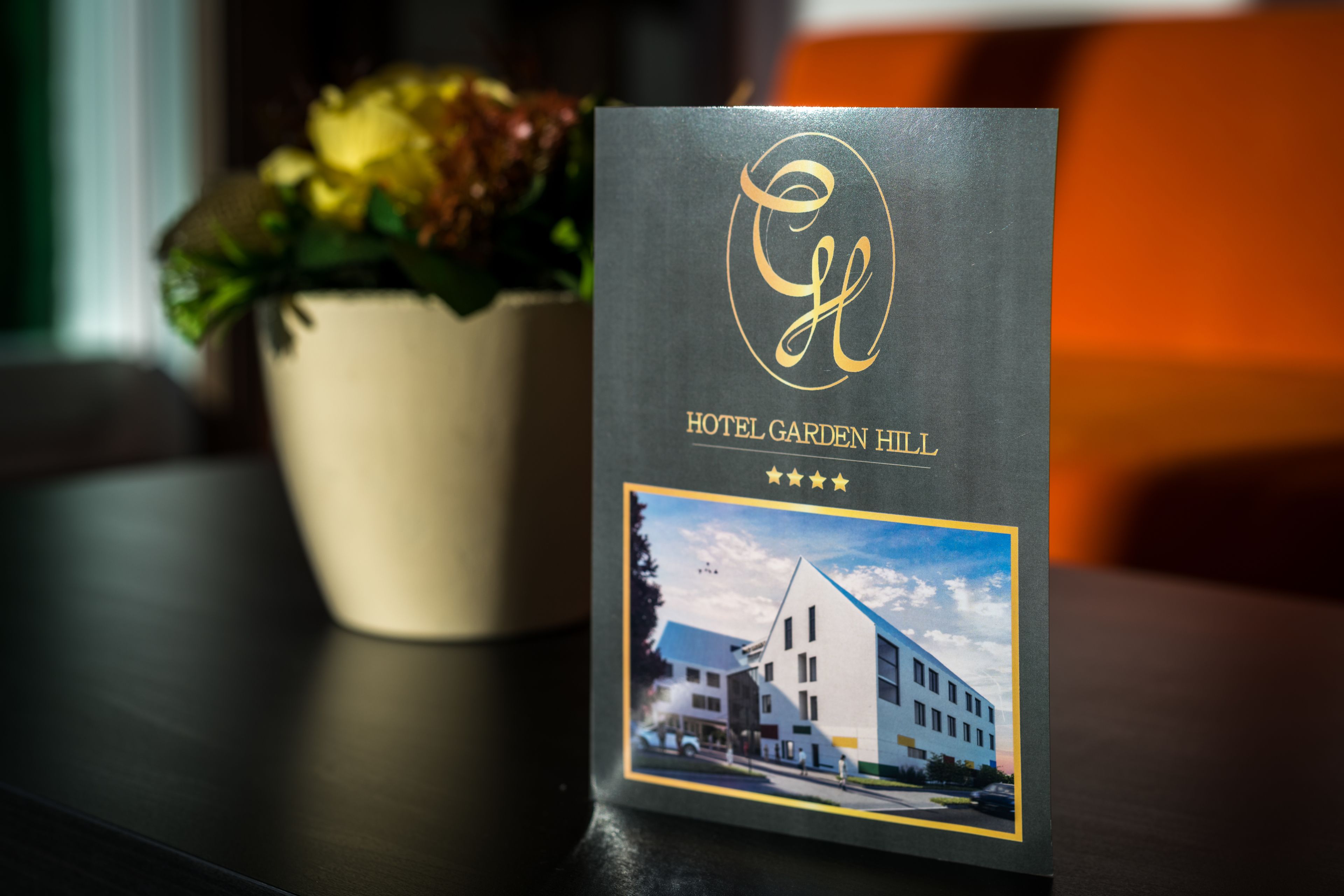 A hotel brochure with a logo, name, and a photo of a building.