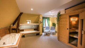 Relax in a spacious bathroom with a bathtub, shower area, and comfortable seating.