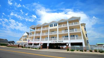 Experience the classic charm of Hotel Maria, featuring a balcony with views of the surrounding area and a symmetrical facade.