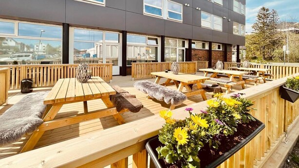 A modern building with a sign reading "MARINA HOTEL". - Marina Hotel Lofoten (Vagan)