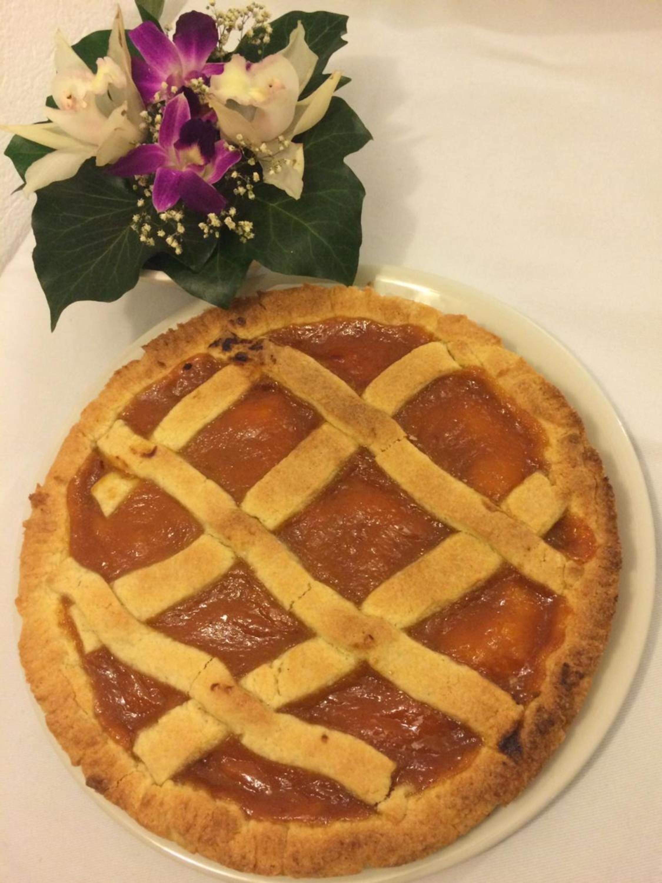 A pie with a lattice crust on a white plate.