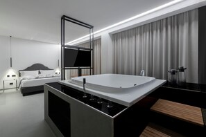 A modern bathroom with a large bathtub, a separate shower area, and a vanity with a mirror. - Suite Palermo Apartment (Palermo)