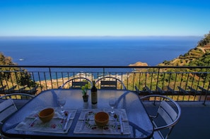 Dine al fresco with a scenic ocean view from your balcony.