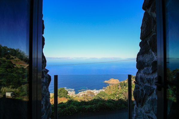 Enjoy breathtaking ocean views from this balcony, overlooking a distant island and the endless horizon.