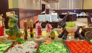 A buffet with various food items, including salads, fruits, and a decorative donkey statue. - Elena Hotel - All Inclusive (Golden Sands)