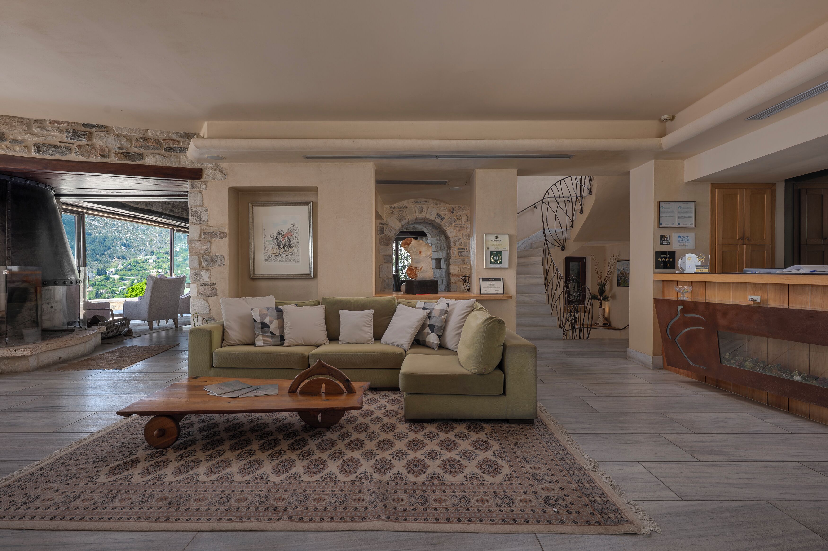 A spacious living area with a sofa, coffee table, and patterned rug.