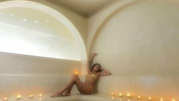 Relax in a serene space with a curved ceiling and a central stone basin, perfect for unwinding.