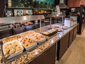 A buffet with various pasta dishes, a fish dish, and a seafood salad. - Mimosa Sunshine Hotel COOEE - All Inclusive (Golden Sands)
