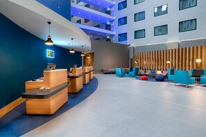 A hotel lobby with reception desks, seating areas, and a high ceiling with a starry design. - Holiday Inn Express London Heathrow T4 by IHG (Hounslow)