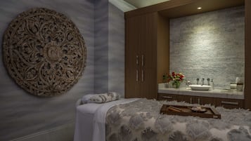 Experience comfort and elegance in this stylish room, featuring a large circular wall decoration, a plush bed, and a modern bathroom with a large mirror and toiletries.