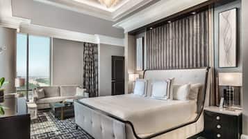 Un espacioso dormitorio con una cama grande, un sofá y vistas a la ciudad.
