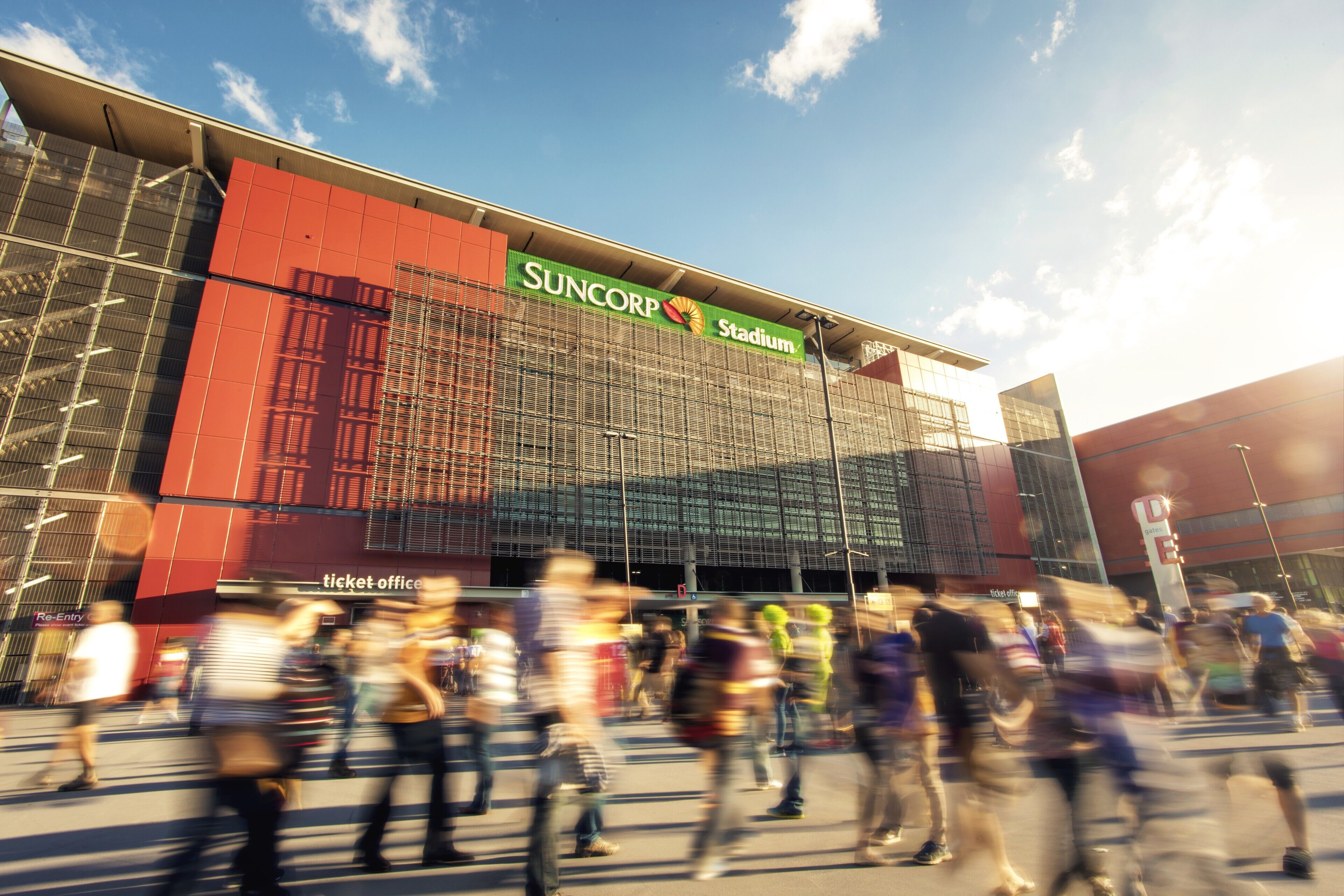 A stadium with a ticket office and a large glass facade.