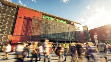 A stadium with a ticket office and a large glass facade.